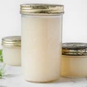 two small jars and a large one filled with chicken broth