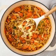 a pot of spicy chicken noodle soup
