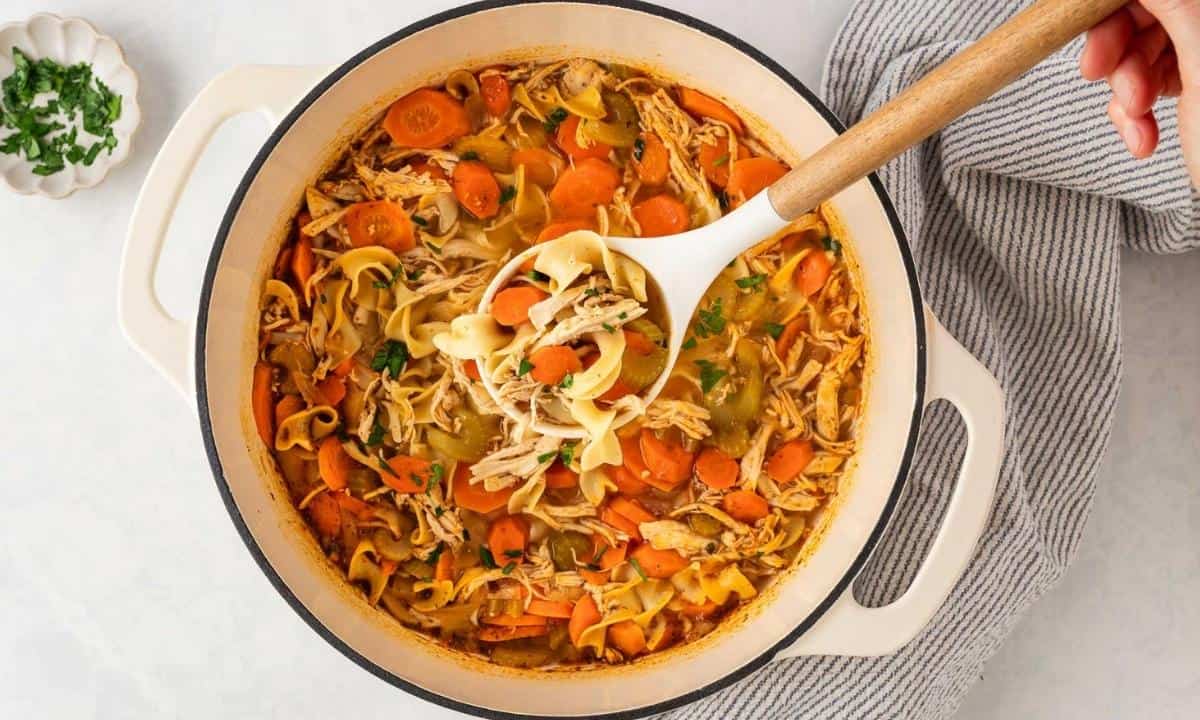 a pot of spicy chicken noodle soup