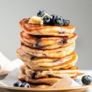 large stack of pancakes with blueberries in them
