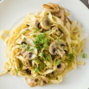 top view of mushroom garlic pasta in a white dish