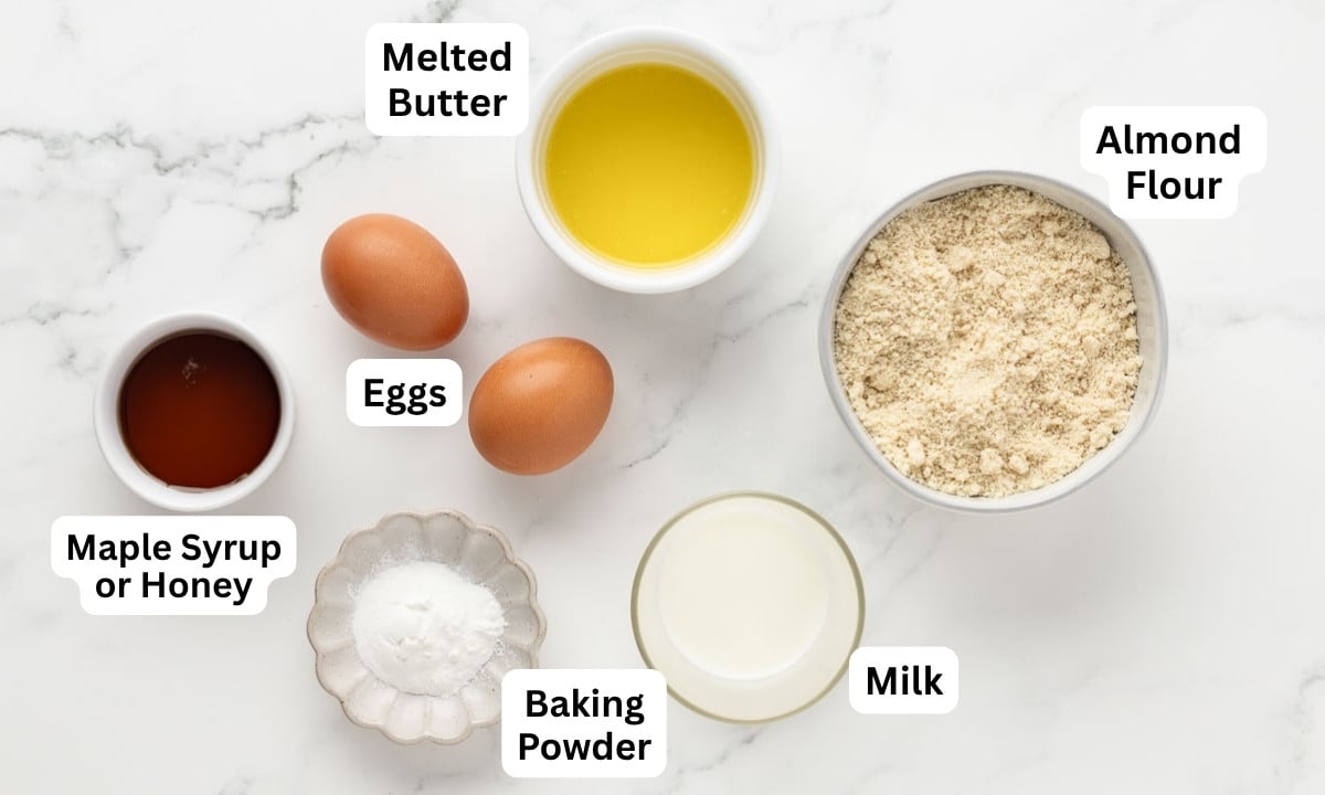 overhead view of 6 simple ingredients to make almond flour pancakes.