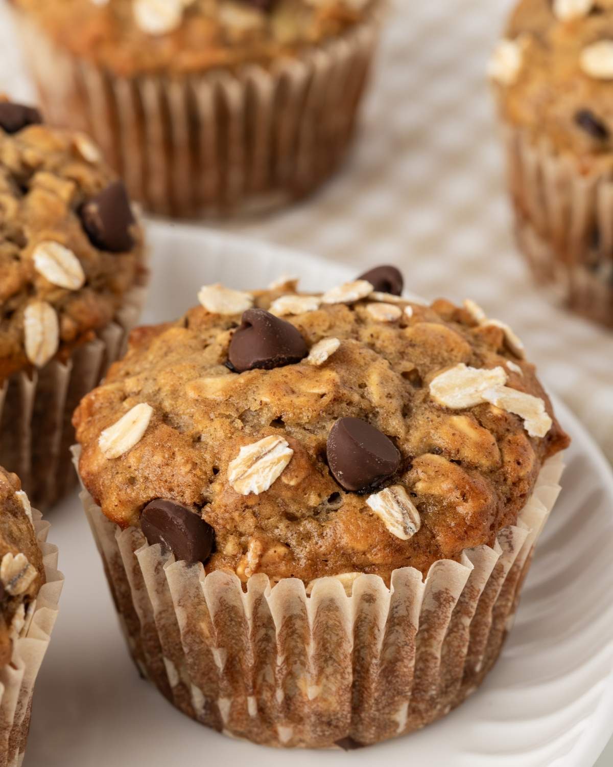 close up of a chocolate chip banana oatmeal muffin on a plate