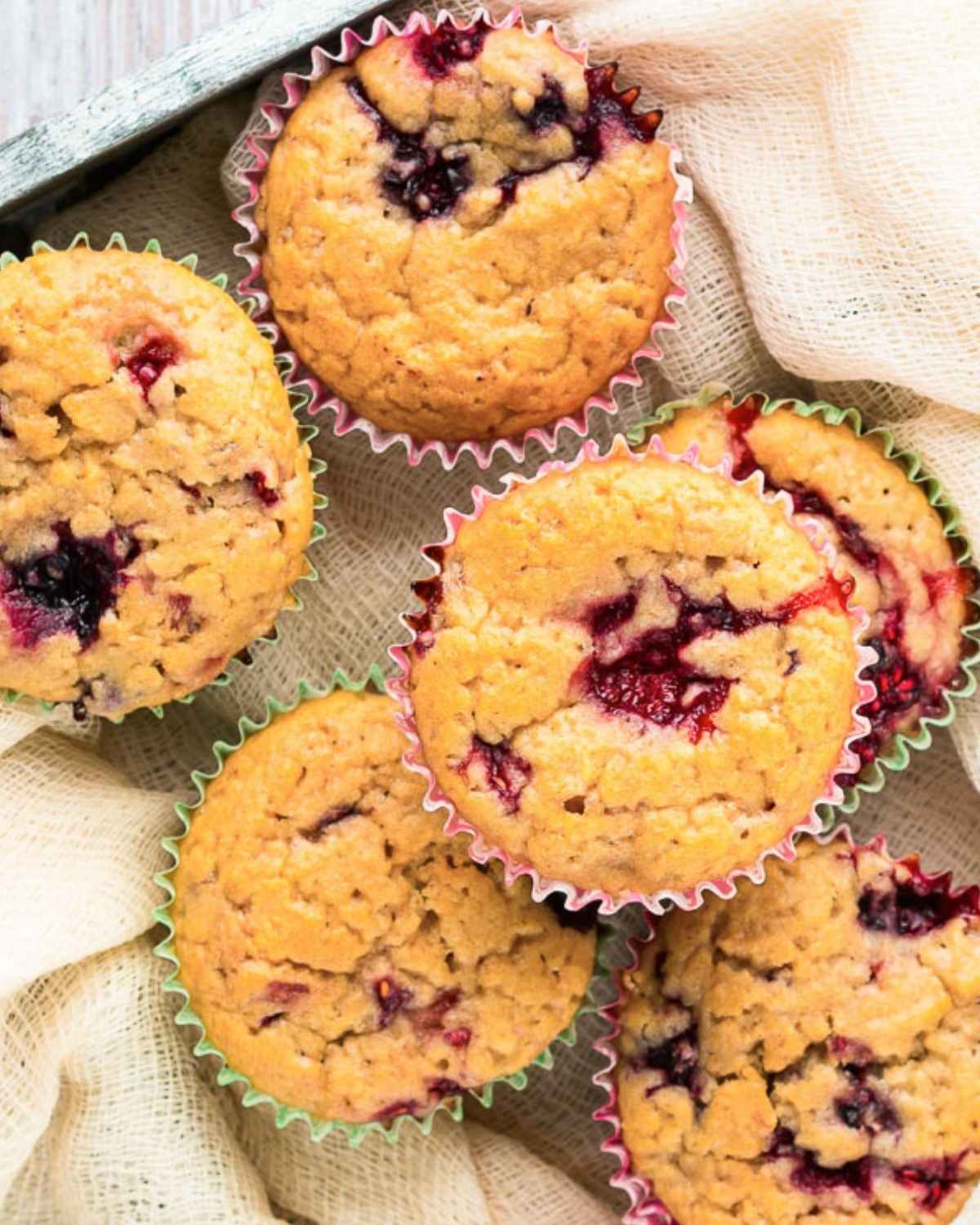 top view of six mixed berry muffins