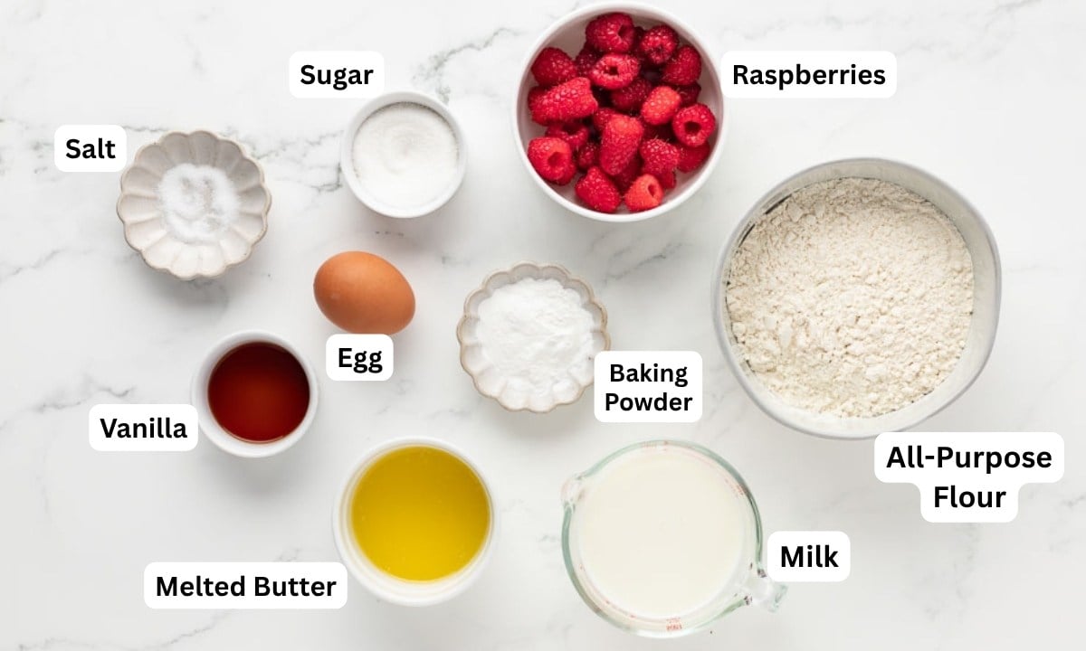 overhead view of labeled ingredients to make pancakes with raspberries