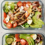 top view of two glass lunch containers with cobb salad