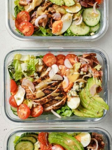 top view of three glass lunch containers with cobb salad
