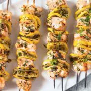 four grilled salmon kabobs with lemon slices