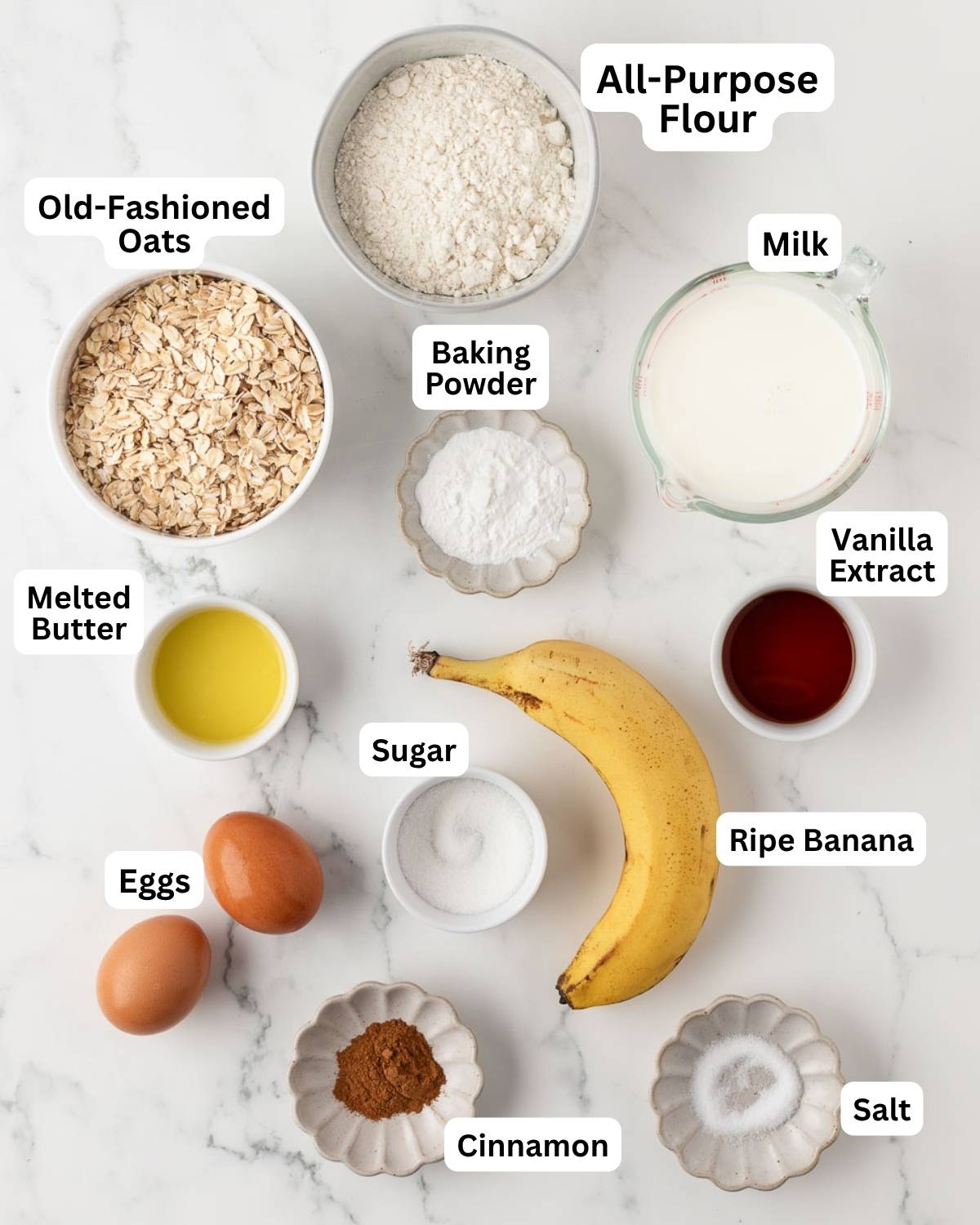 overhead view of labeled ingredients to make oatmeal banana pancakes