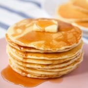 stack of homemade mcdonald's pancakes on a plate topped with a pat of butter and syrup over the top