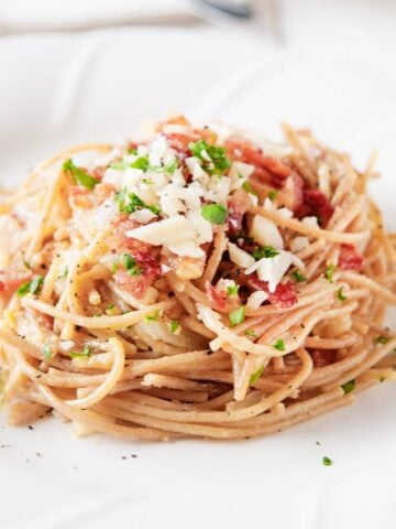 a serving of bacon carbonara in a white dish