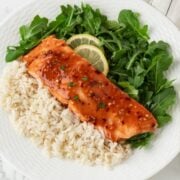 a dish with hot honey salmon, white rice, and greens