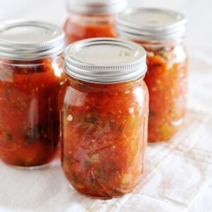 4 pint jars filled with homemade canned salsa