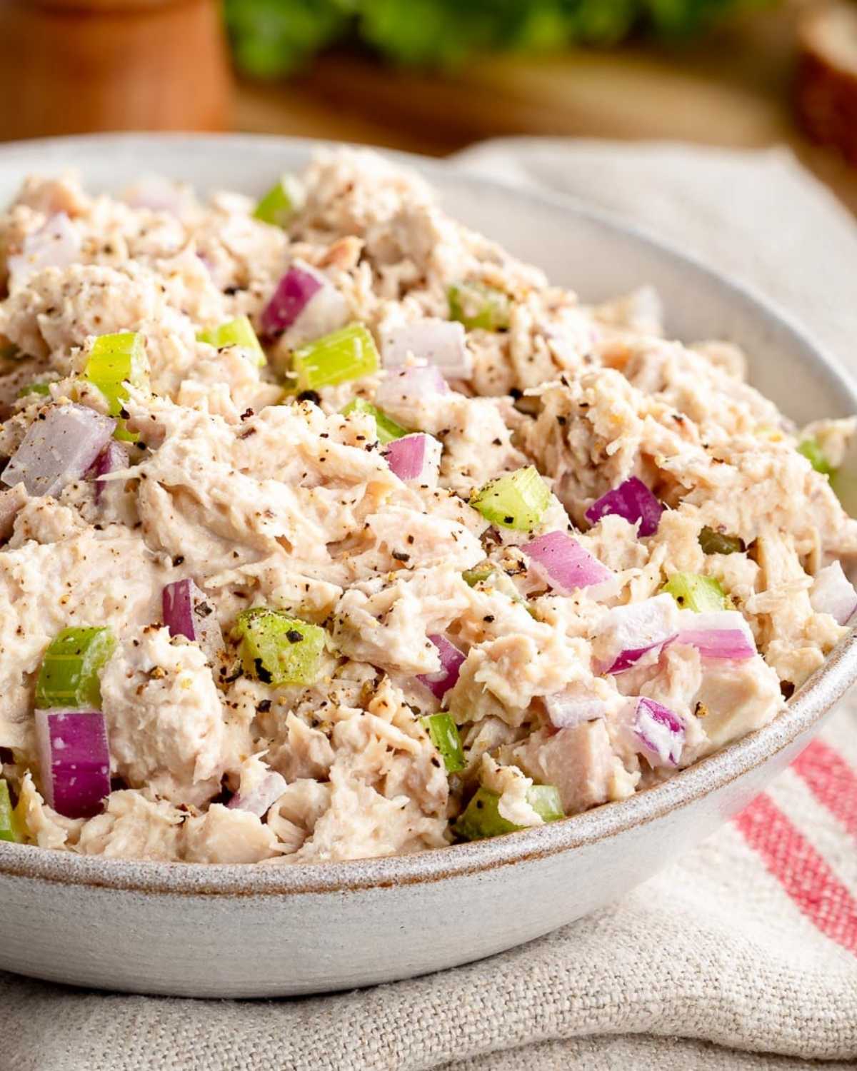 a bowl with cottage cheese tuna salad with chopped red onion and celery