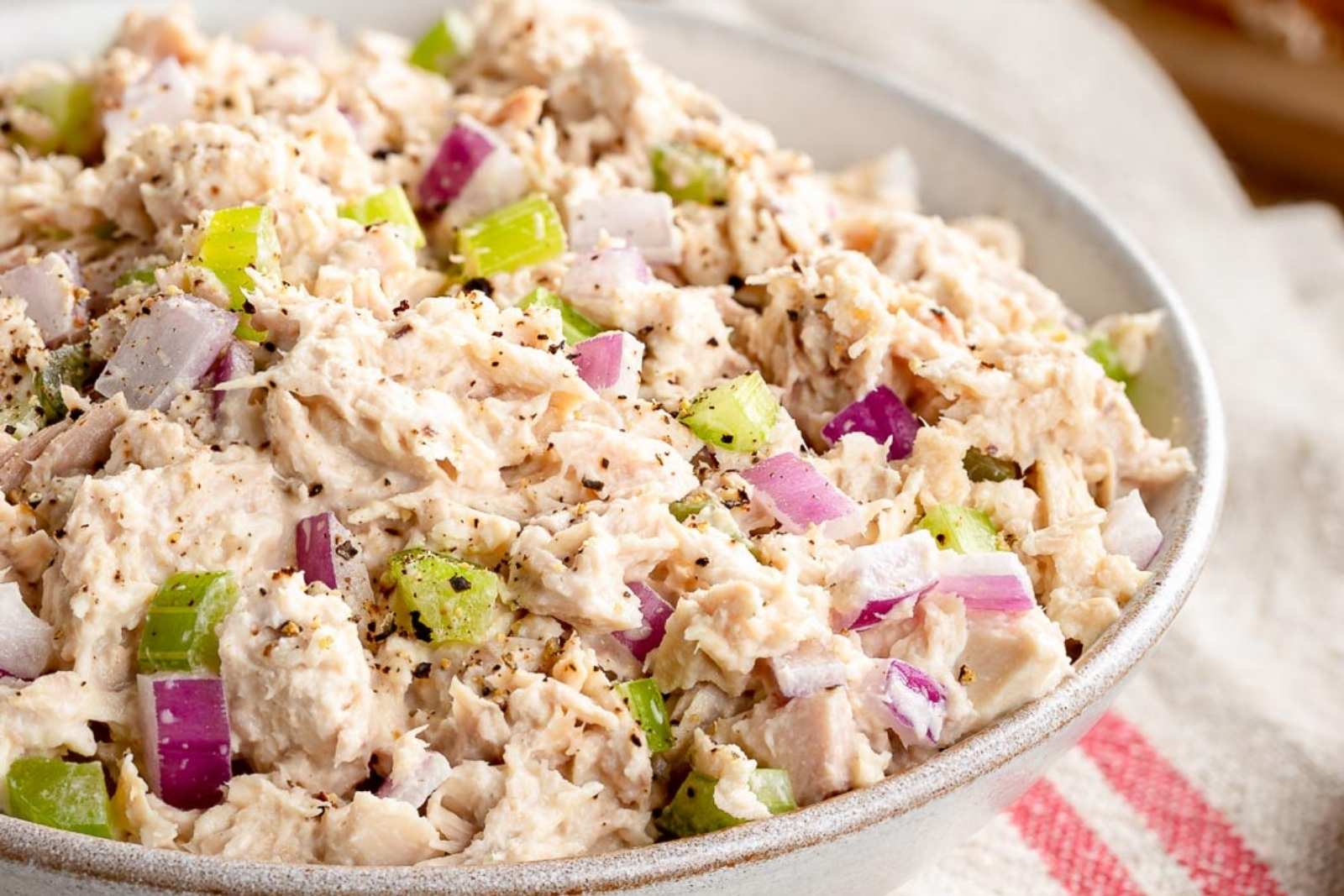 a bowl with cottage cheese tuna salad with chopped red onion and celery