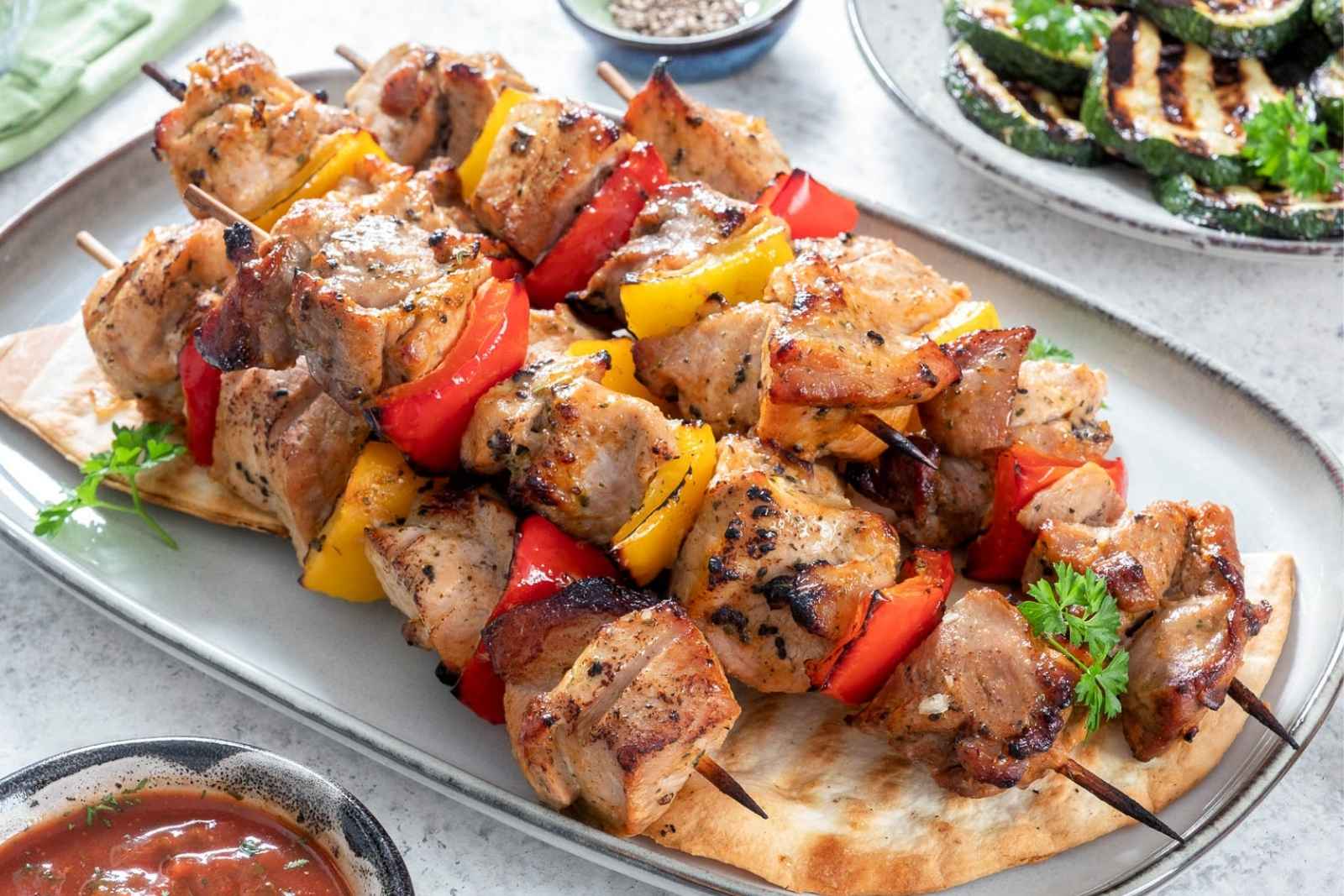 grilled pork kabobs on a white dish