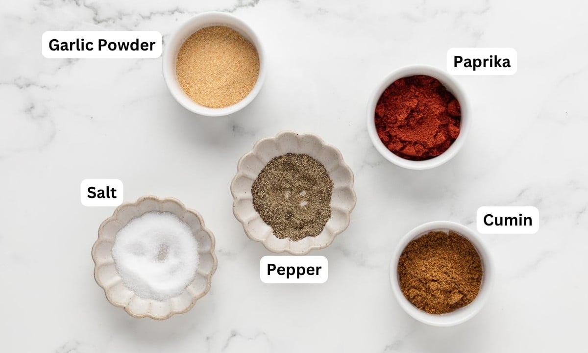 overhead view of seasonings needed to make spanish seasoning mix for rice and chicken