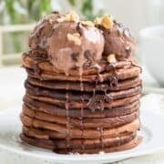 a stack of chocolate pancakes topped with chocolate ice cream