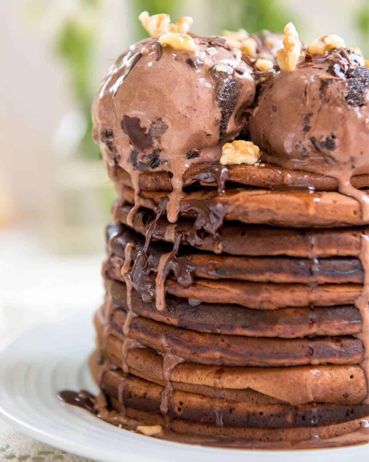 a stack of chocolate pancakes topped with chocolate ice cream