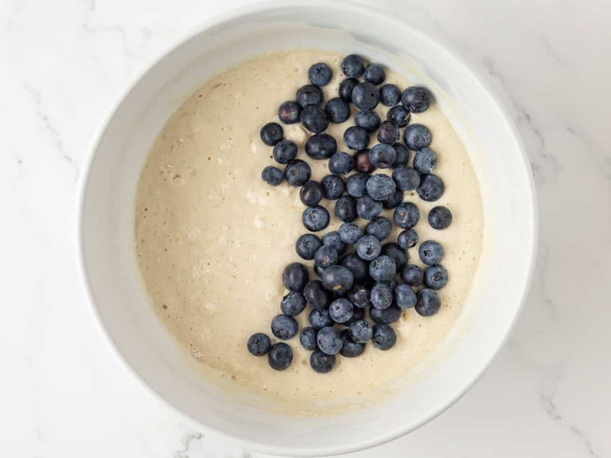 overhead view of adding blueberries to protein pancake batter
