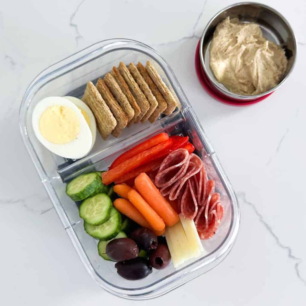 charcuterie lunchbox and a small container with hummus