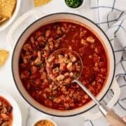 ladling out ground chicken chili out of a pot