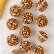 overhead view of healthy banana oatmeal muffins on the counter next to bananas
