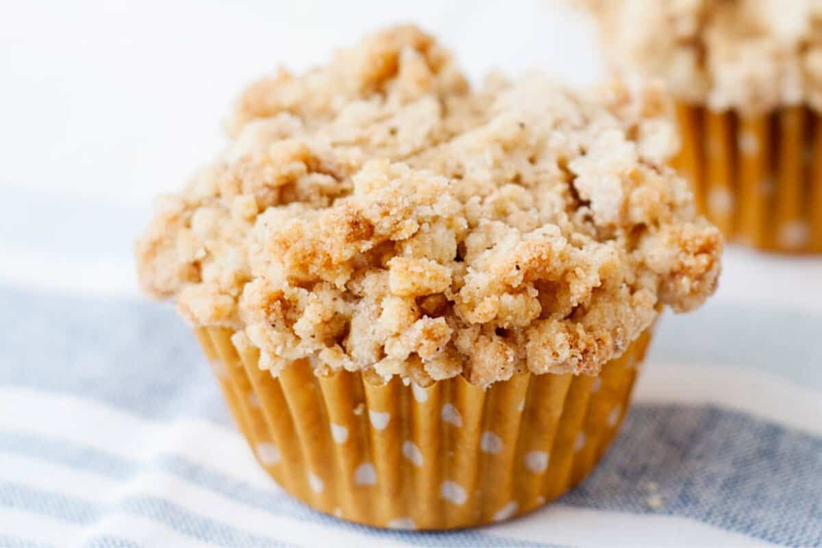 front view of a pumpkin coffee cake muffin with a cinnamon crumble topping