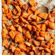 overhead view of roasted sweet potato cubes on a sheet pan