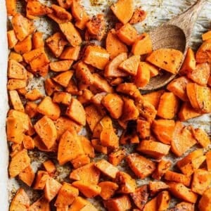 overhead view of roasted sweet potato cubes on a sheet pan