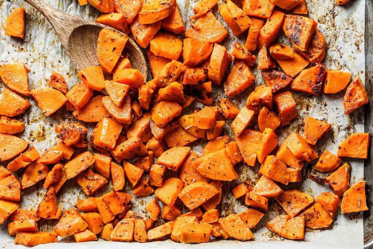 overhead view of roasted sweet potato cubes on a sheet pan