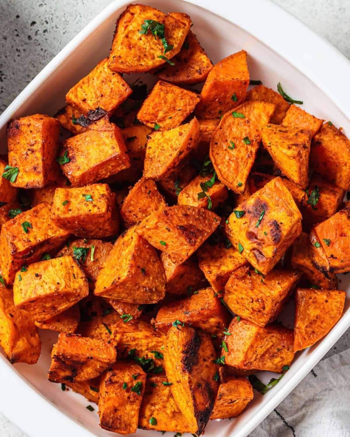 overhead view of roasted sweet potato cubes in a serving dish