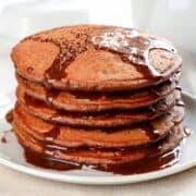 stack of chocolate pancakes made with pancake mix topped with chocolate syrup
