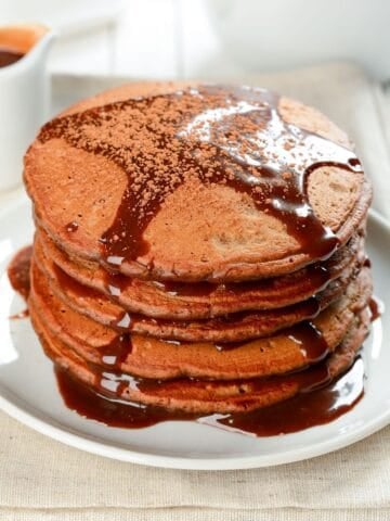 stack of chocolate pancakes made with pancake mix topped with chocolate syrup