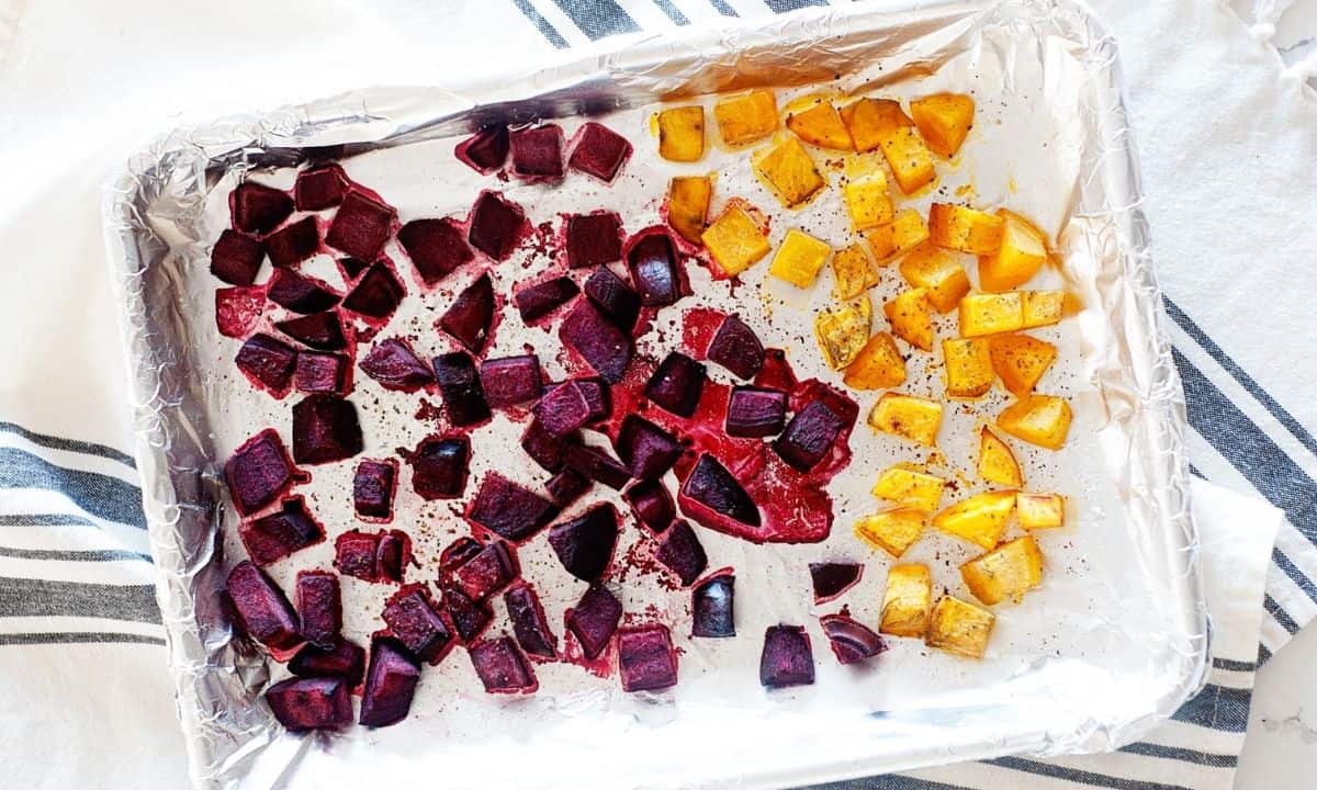 diced roasted beets and butternut squash in a foiled baking sheet