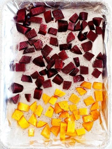diced roasted beets and butternut squash in a foiled baking sheet