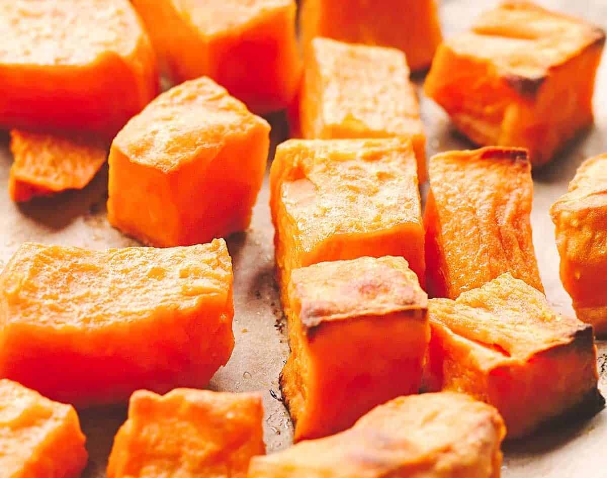 roasted cubed sweet potatoes on a sheet pan
