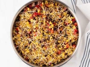 taco skillet with shredded cheese on top