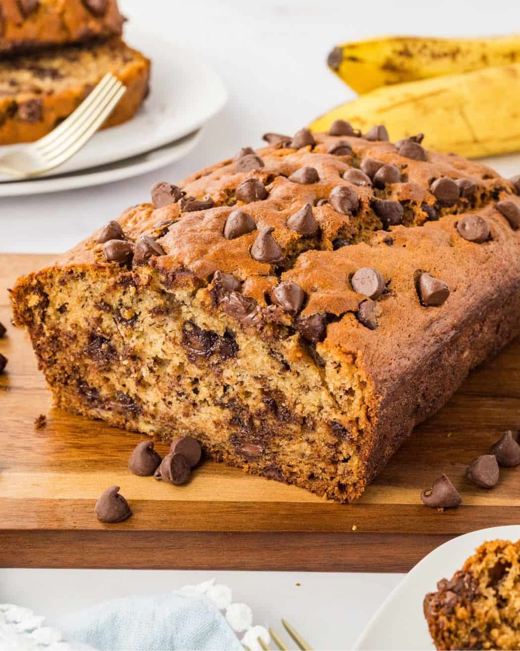 front view of a loaf of banana bread sliced to show the chocolate chips inside
