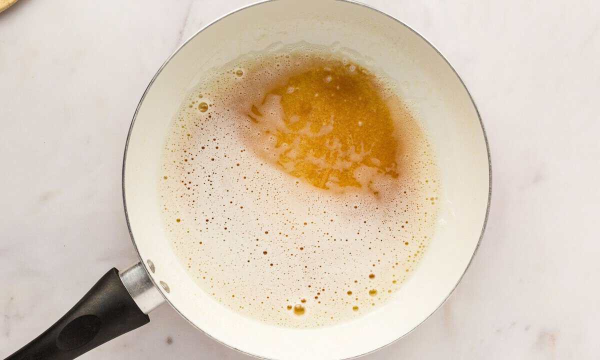 browning butter in a small pot. image shows caramel color of butter