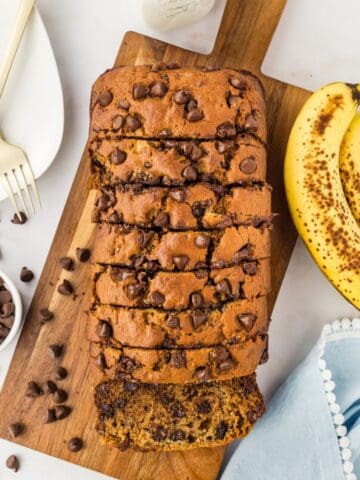 overhead view of brown butter banana bread on a board sliced