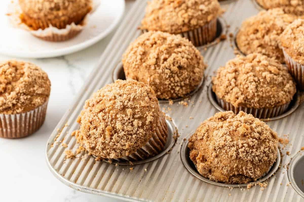 sweet potato muffins in a baking pan after baking with a brown sugar topping