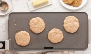 overhead view of pancake batter in a griddle